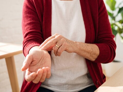 Woman checking pulse on wrist