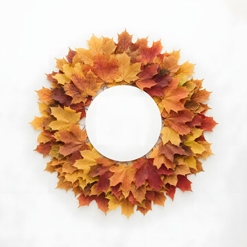 Autumn maple leaves arranged in a circular wreath on a white background