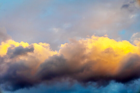 Golden illuminated stratocumulus clouds with atmospheric gradient during sunset