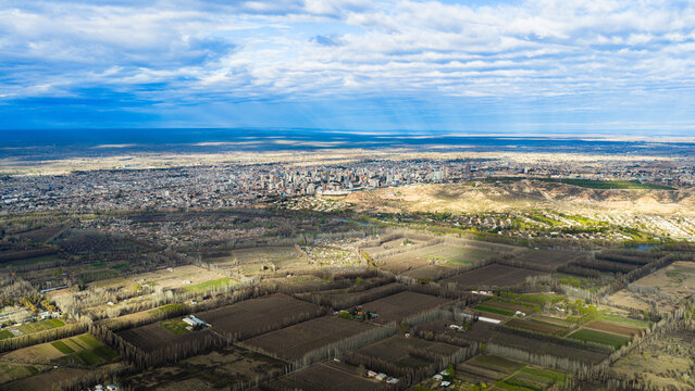 Neuqu&eacute;n's urban sprawl fading into the arid Patagonian steppe, seen from above, Argentina.