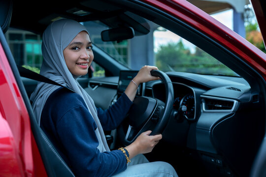 Happy young woman in a car