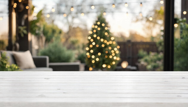 Empty white wooden tabletop with a blurred Christmas tree and string lights in the background
