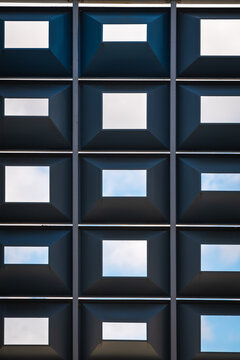 Modern Architectural Grid With Geometric Square Openings and Blue Sky Views