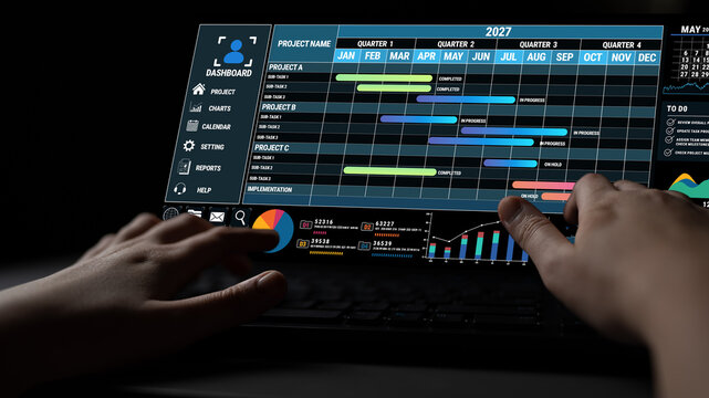 Hands Interacting with Digital Dashboard Displaying Project Management Schedule and Data Visualization for 2027 Timeline Overview Fluxor.