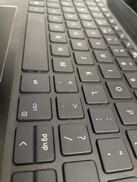 Close-up of a laptop keyboard with black keys