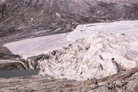 Rh&ocirc;ne Glacier Covered with White Protective Blankets to Reduce Melting, View Toward the Glacier Entrance with Dramatic Ice Formations and Glacial Lake, Swiss Alps, , Switzerland, 2018