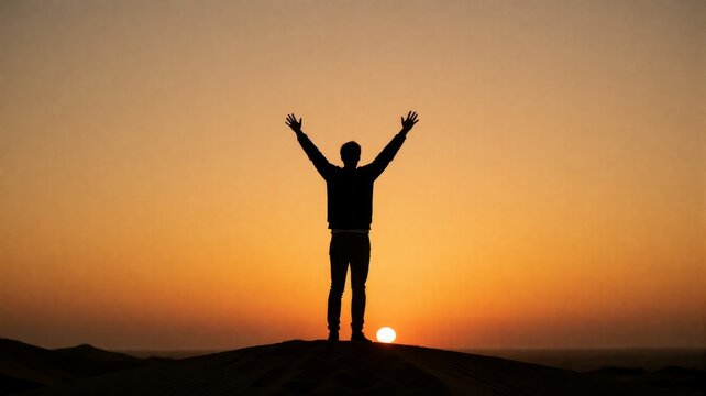Person celebrates victory or peace atop a desert ridge at sunrise or sunset