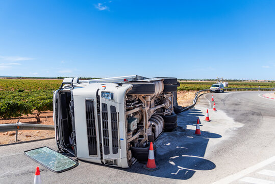 Truck with refrigerated semitrailer overturned in a roundabout