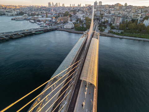Turkey, Istanbul 06 10 2025: Early morning sunrise drone photo overlooking Halic station on Golden Horn Metro Bridge with Sokullu Mehmet Pasha Mosque and cityscape in background.