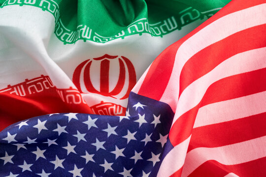Flags of the United States and Iran. Concept of international relations.