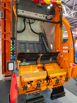 Birmingham, UK - September 17th September: Rear loading refuse collection truck hopper and compactor mechanism with open twin loading pockets inside industrial exhibition hall showcase