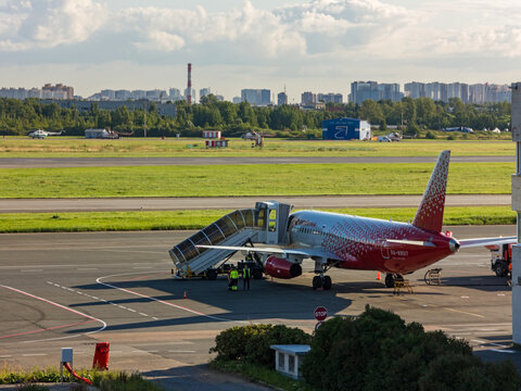 Sukhoi Superjet 100-95B regional passenger airplane with registration RA-89017 of Rossiya Airlines parked at Pulkovo International Airport (LED) tarmac during ground handling operations