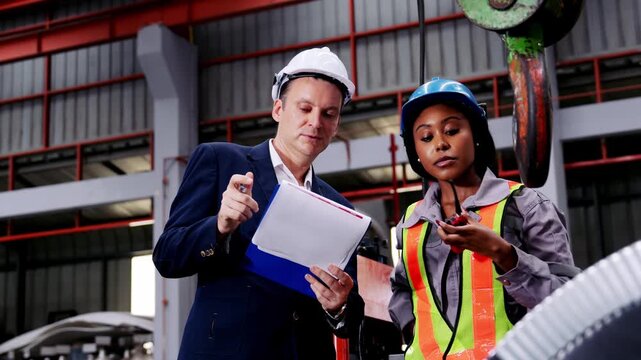 Professional industrial concept metal sheet factory engineer an industrial plant feeling focused serious reviewing technical data facility site