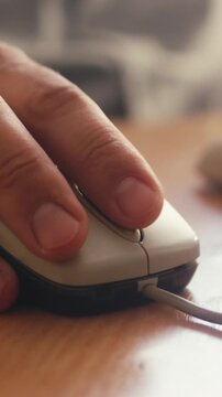 Close up of hand using a computer mouse on a desk