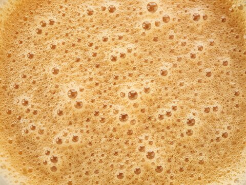 Golden brown puffed popcorn kernels in close-up macro shot with even distribution and textural detail