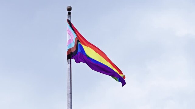 LGBT community. Tolerance and equality. World gay pride. Rainbow gay flag. Pride month. LGBTQ rainbow flag. LGBT rainbow flag waving against sky. Symbol of pride and LGBTQ. Colorful pride flag