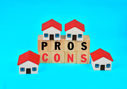 Miniature houses surrounding pros and cons blocks representing residential property comparison and buying decisions.
