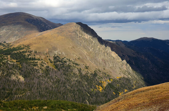 looking out at  forests, alpine tundra, the never summer mountains and storm clouds in fall from  the lava cliffs overlook along trail ridge road in rocky mountain national park,  near estes park, col
