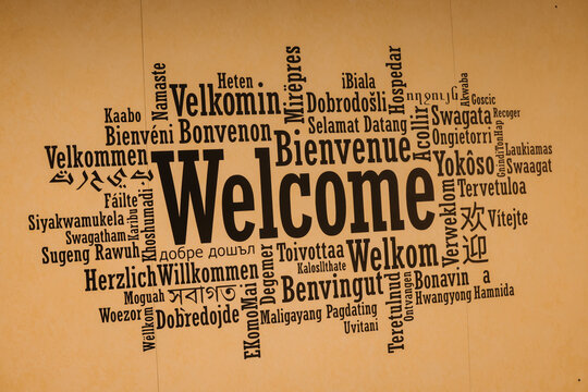 Word cloud of the word welcome in multiple international languages on a textured background