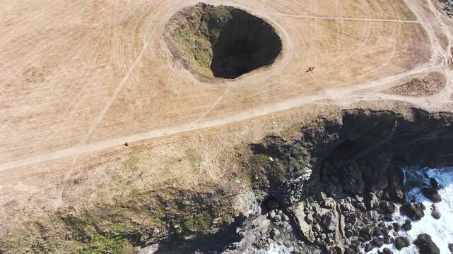 Top Down View of Trevone Round Hole over Trevone Bay from a drone, Trevone, Padstow, Cornwall, England, United Kingdom, Summer 2026