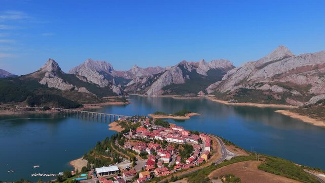 Summer rural tourism in the village of Ria&ntilde;o in Le&oacute;n, Spain. Aerial view of riano village on a peninsula in the spanish mountains