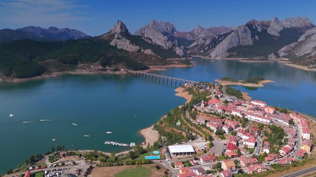 Summer rural tourism in the village of Ria&ntilde;o in Le&oacute;n, Spain. Aerial view of riano village surrounded by a reservoir and mountains in spain