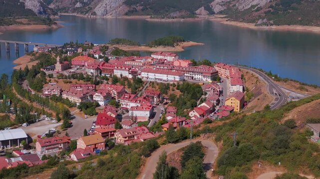 Summer rural tourism in the village of Ria&ntilde;o in Le&oacute;n, Spain. Aerial view of riano village reservoir and cantabrian mountains in spain