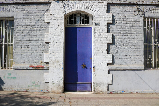 Purple Door on a Weathered Santiago Facade