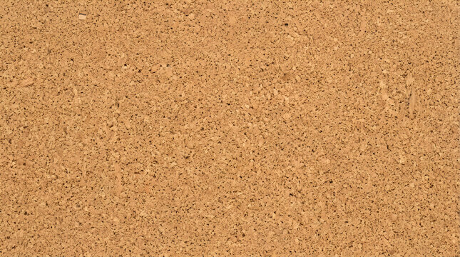 Natural cork board texture background, brown granular bulletin board surface, organic wood grain material for office memo and message board design
