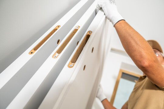 Worker handling interior doors with empty lock recesses