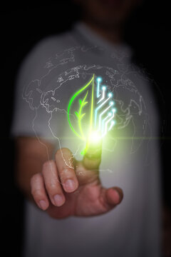 Finger touches hybrid leaf and digital circuit board inside earth globe outline. Activation of eco-friendly green technology, sustainable digital innovation, global ESG solutions. Vertical photo.