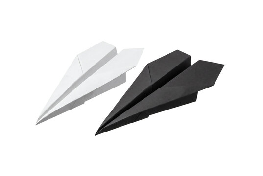 Minimalist folded paper airplanes featuring one pristine white origami plane flying beside a sleek matte black stealth paper glider. Creative graphic asset isolated on white background template.