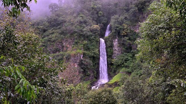 Huai Nam Yen Waterfall cascading through lush tropical rainforest in the rainy season in Omkoi District Chiang Mai, Thailand
