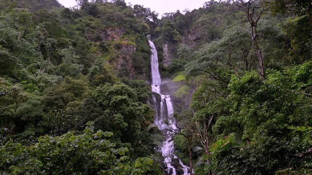 Huai Nam Yen Waterfall cascading through lush tropical rainforest in the rainy season in Omkoi District Chiang Mai, Thailand