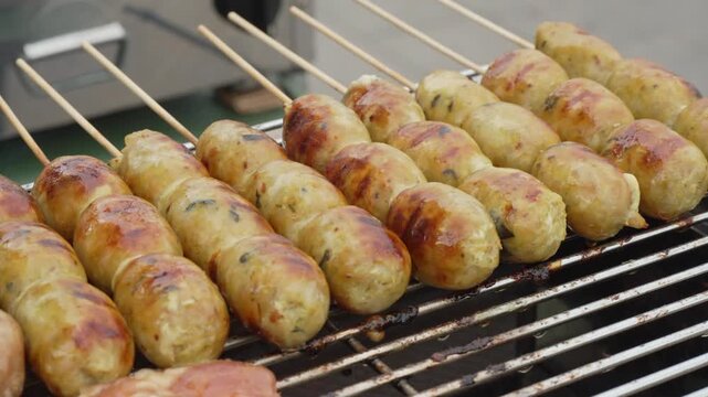 Golden grilled food skewers displayed at a street market