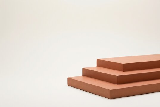 Minimalist terracotta stepped podium against off white wall for natural skincare mockup and wellness brand web banner