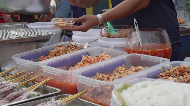 Assorted prepared street food displayed in market trays