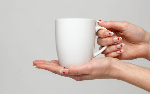 Woman holding a white mug isolated on white background