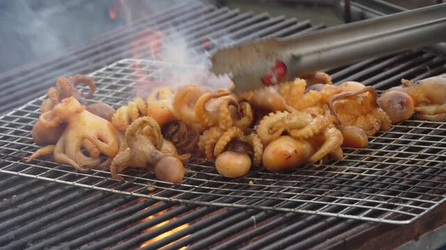 Grilled squid and seafood cooking over a street barbecue