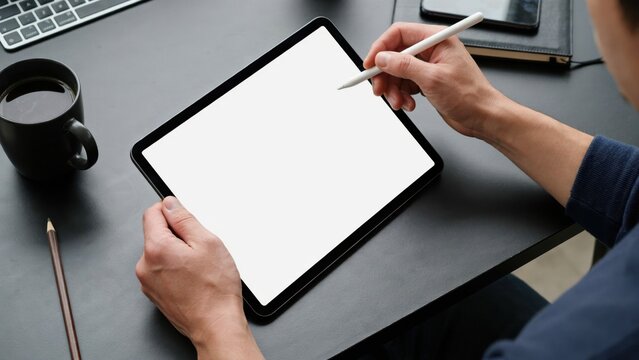 Person using digital tablet with stylus pen