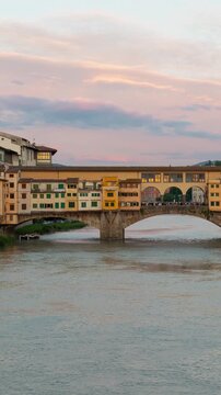 Time Lapse of the famous Ponte Vecchio and Arno River in Florence Italy at sunset. Vertical video.