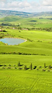 Flying over the beautiful rolling landscape of Tuscany Italy. Vertical video.