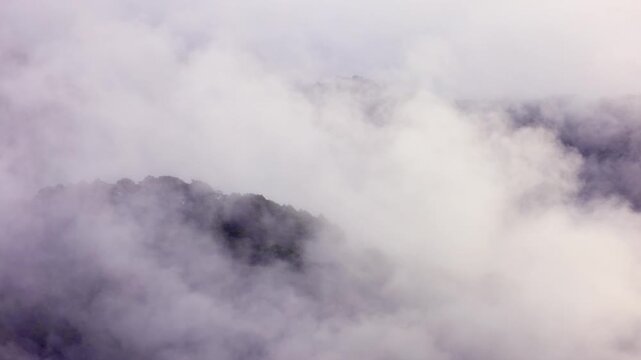 Morning fog covers the mountains near the town of Banaue Philippines.