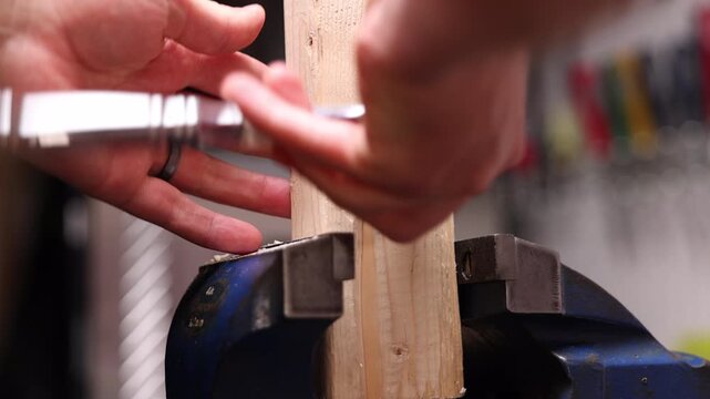 ratchet driver with mechanical sound as it tightens bolt into piece of wood