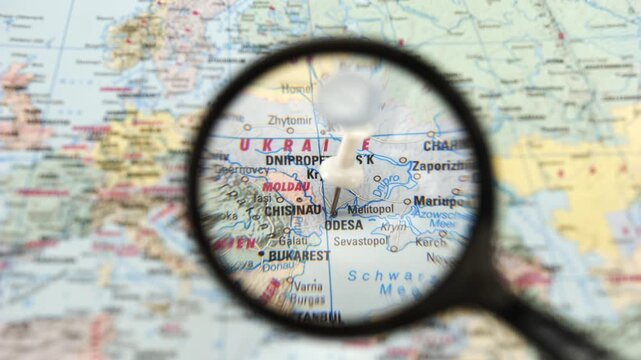 Magnifying glass reveals marked location on map