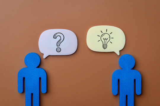 Two blue human figures with question mark and lightbulb speech bubbles. Problem-solving, consultation, idea sharing concept.