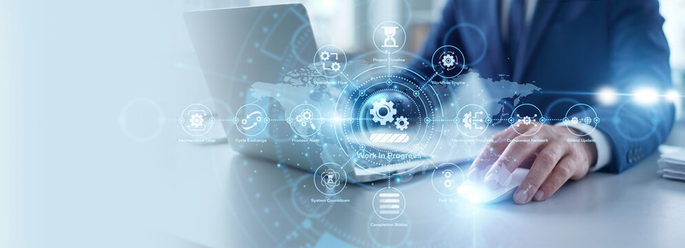 Project manager working on laptop, work in progress and task management. Ongoing professional assignment and development status. Tracking current milestone and pending business operation plan.