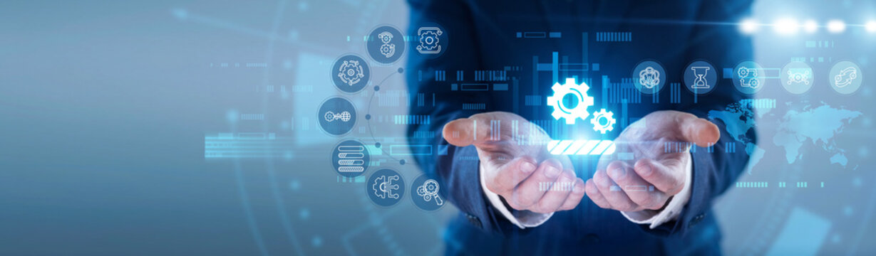 Engineer hands hold glowing WORK IN PROGRESS icon. Technician managing ongoing project tasks, monitoring system development on futuristic virtual screen interface. Concept of continuous updates.