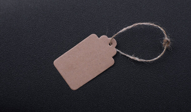 Blank Kraft Paper Tag With String On Black Background