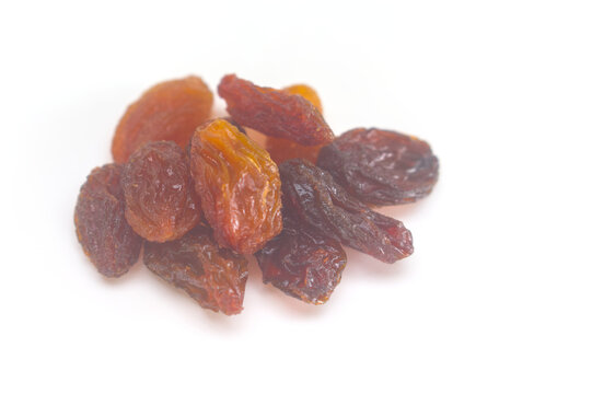 Small pile of raisins close up on a white background